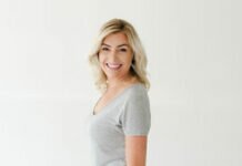 Heather Chauvin - Standing with a white t-shirt staring at the camera and smiling - Interviewed on the Mom Break Podcast